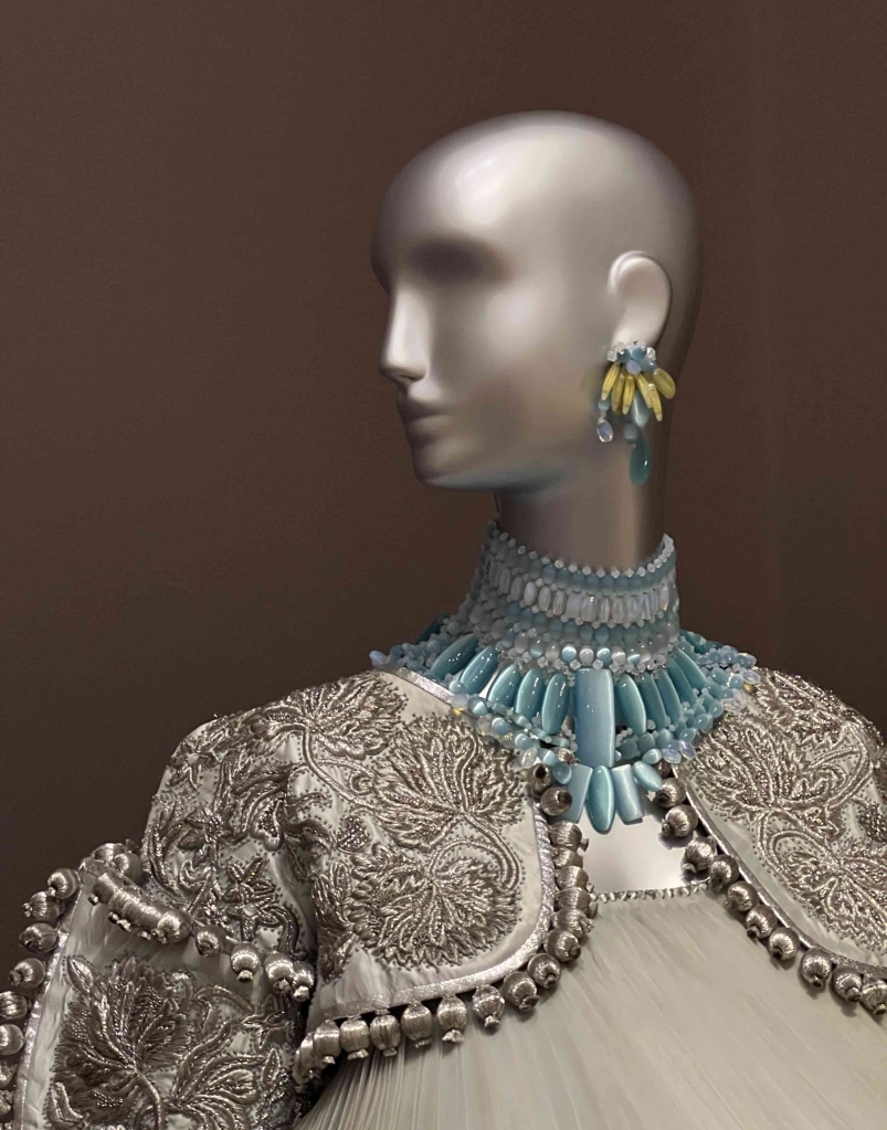 bust with necklase, earrings and bolero
